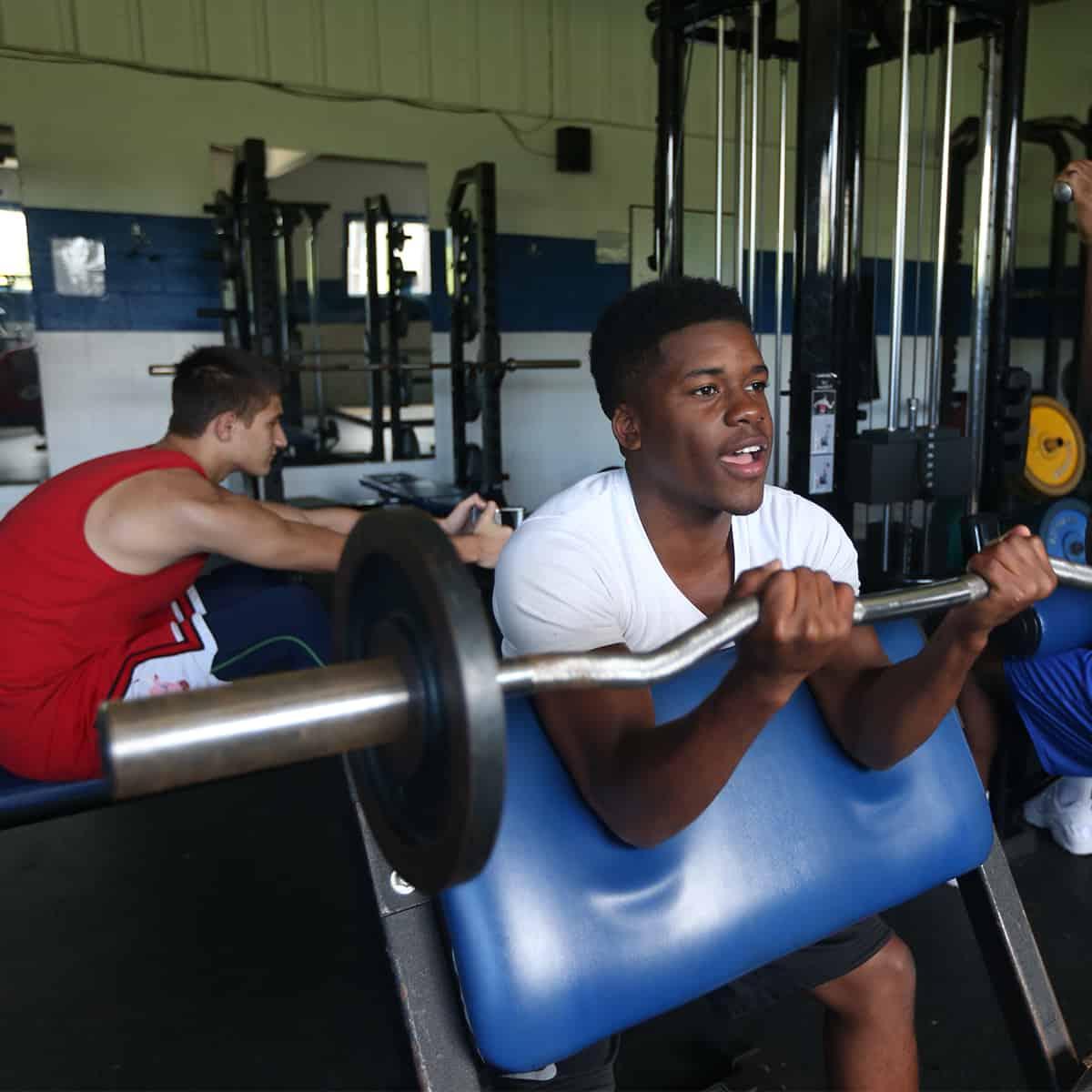 students lifting weights